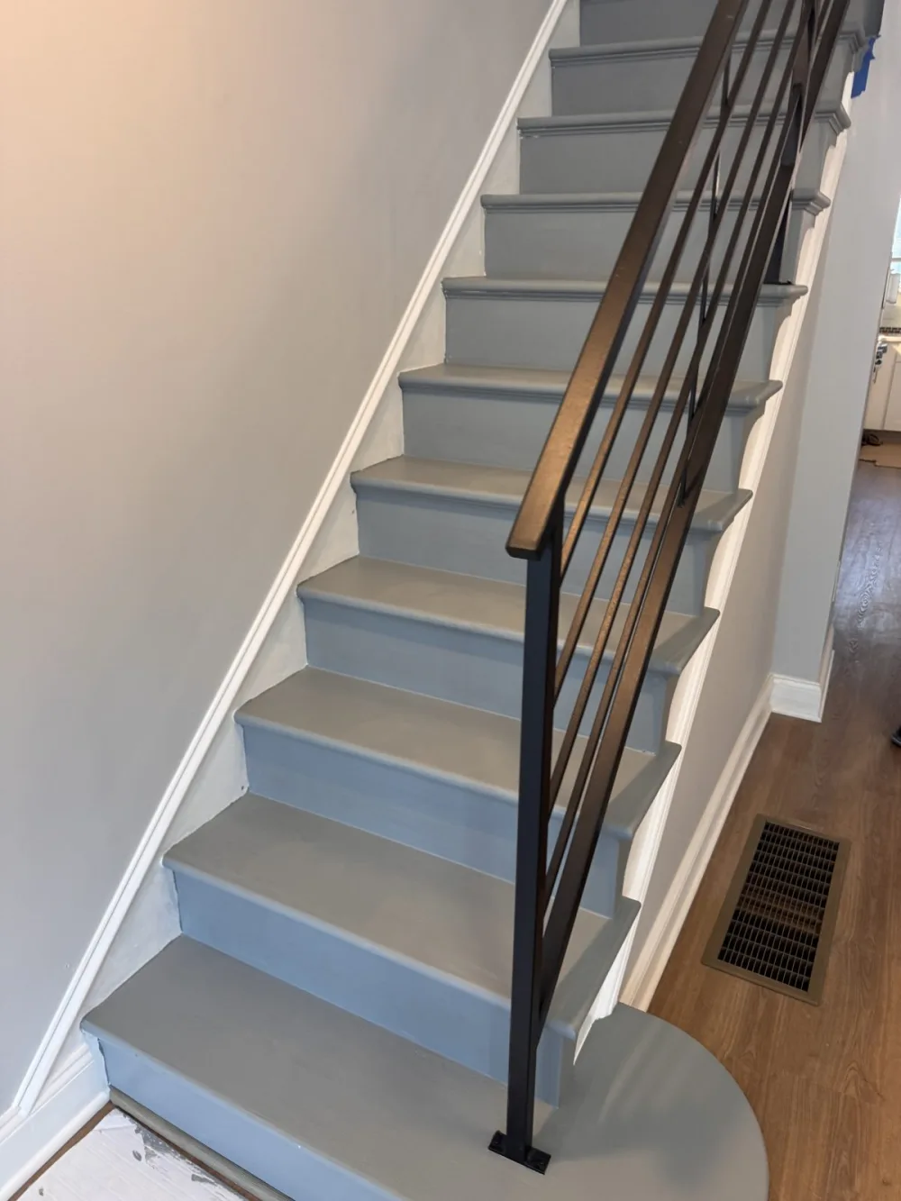 New stairs on 63rd Avenue: gray treads, white risers, black metal railing.