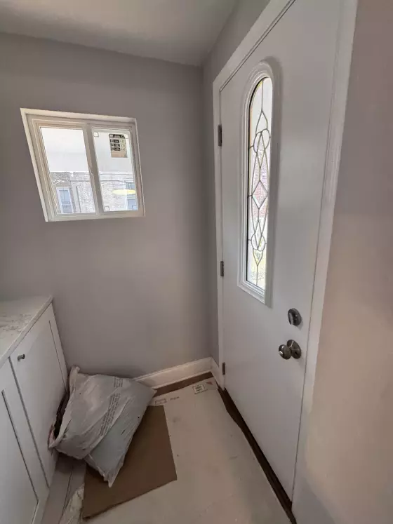 Painted entry with a glass-panel door and a window