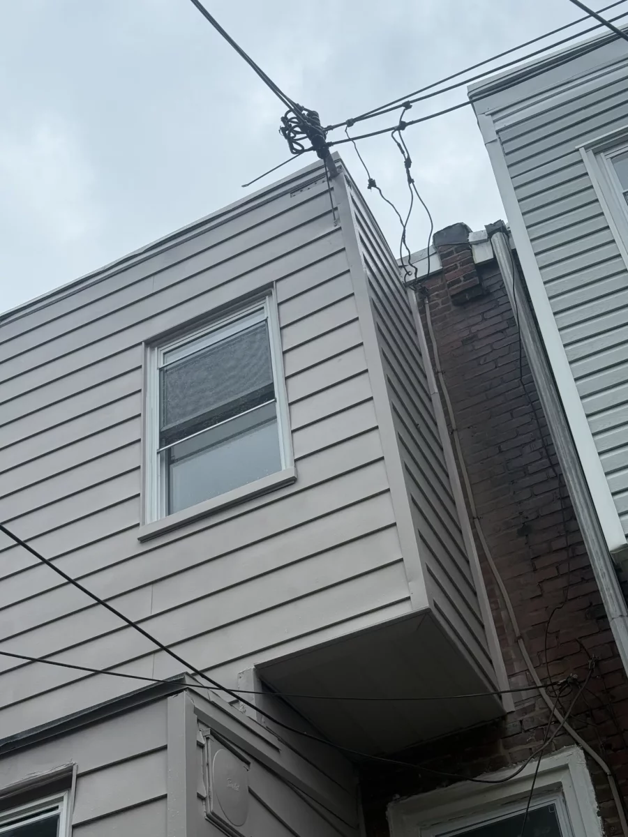 Gray siding and window on the rear of a Philadelphia rowhome