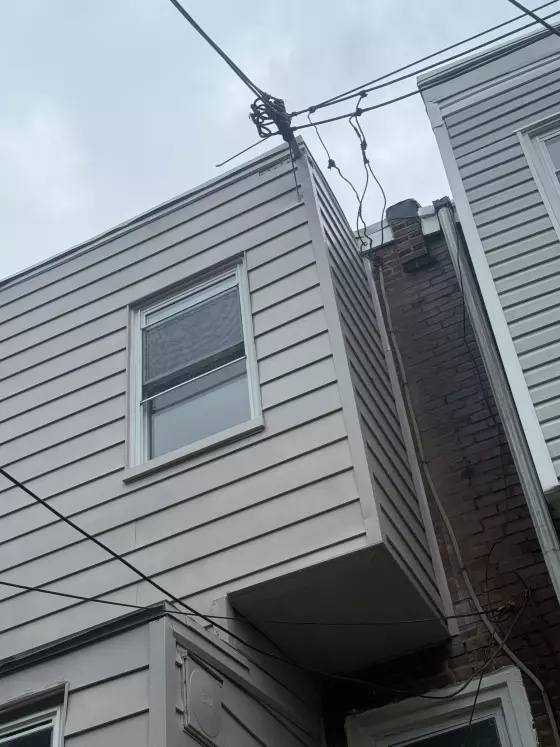 Gray siding and window on the rear of a Philadelphia rowhome