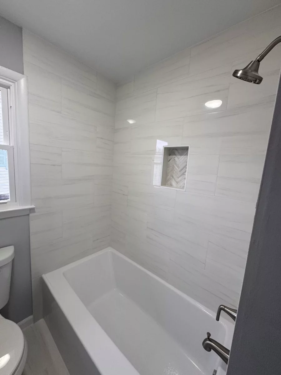 Full-height tile tub surround with brushed-nickel shower trim
