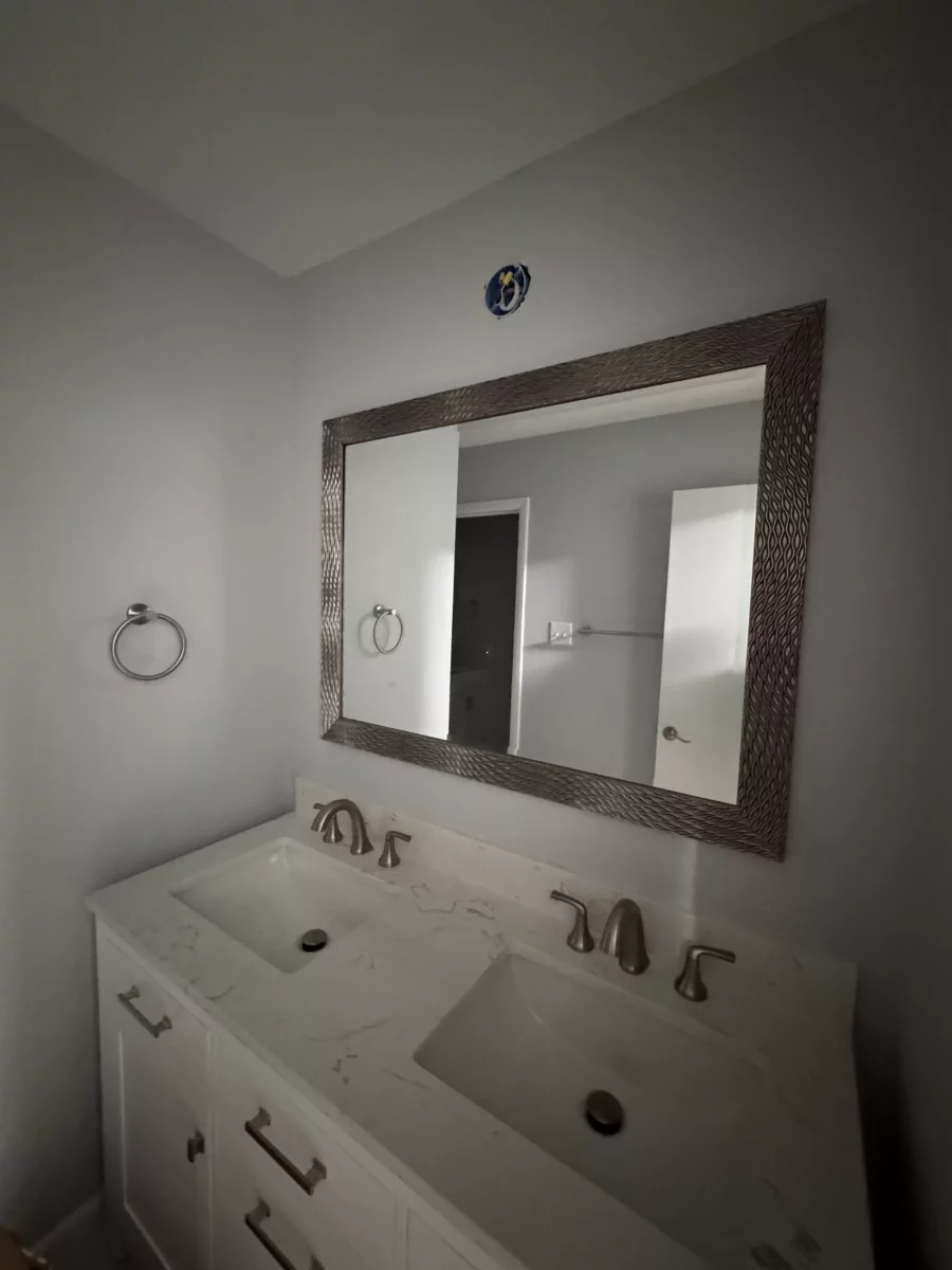 Double vanity and framed mirror with brushed-nickel faucets