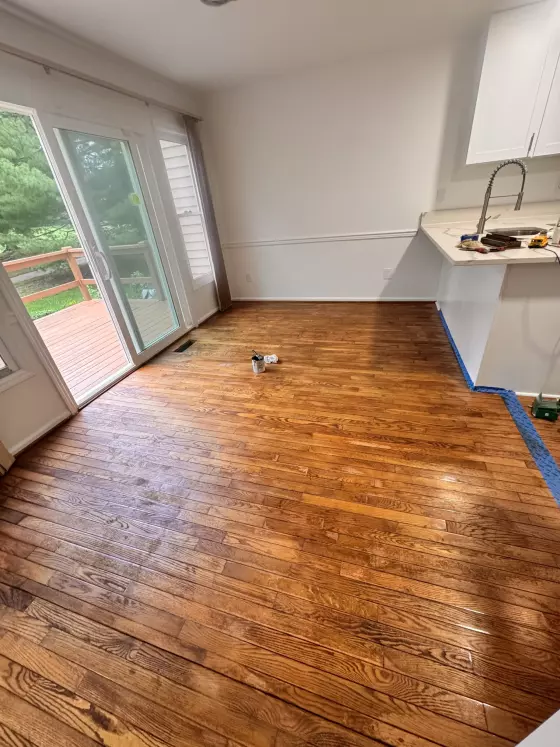 Refinished hardwood floor with a warm glossy finish in a Doylestown, PA kitchen