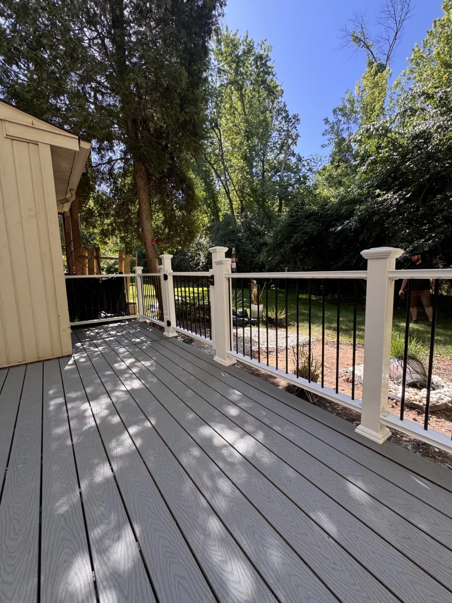 Composite deck and railing along the side of the house