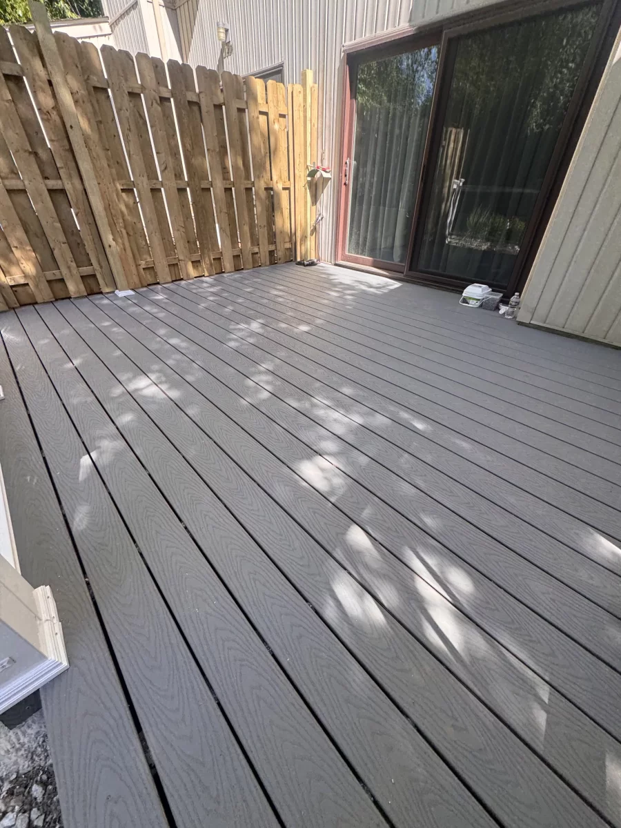 Gray composite decking running to a shadowbox privacy fence