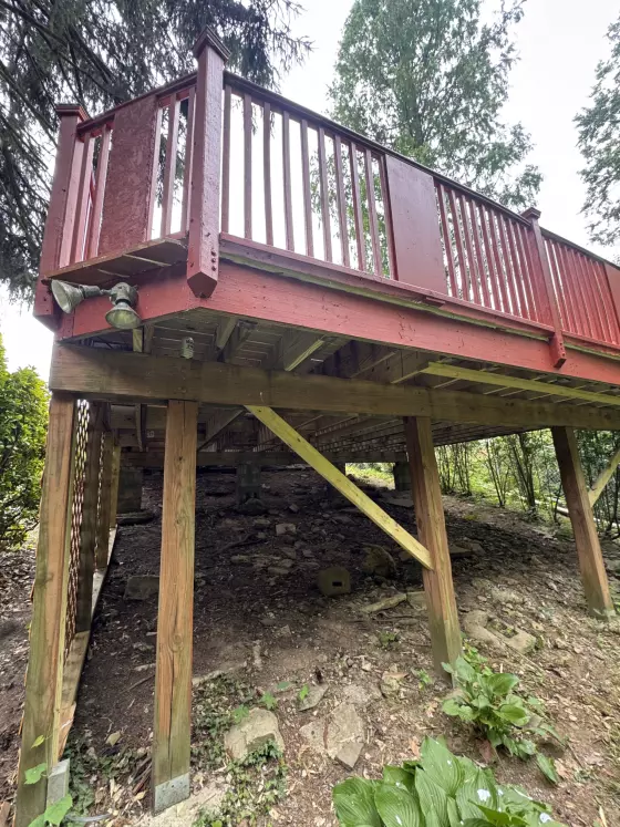 Raised deck section on its posts after the rebuild, stained to match