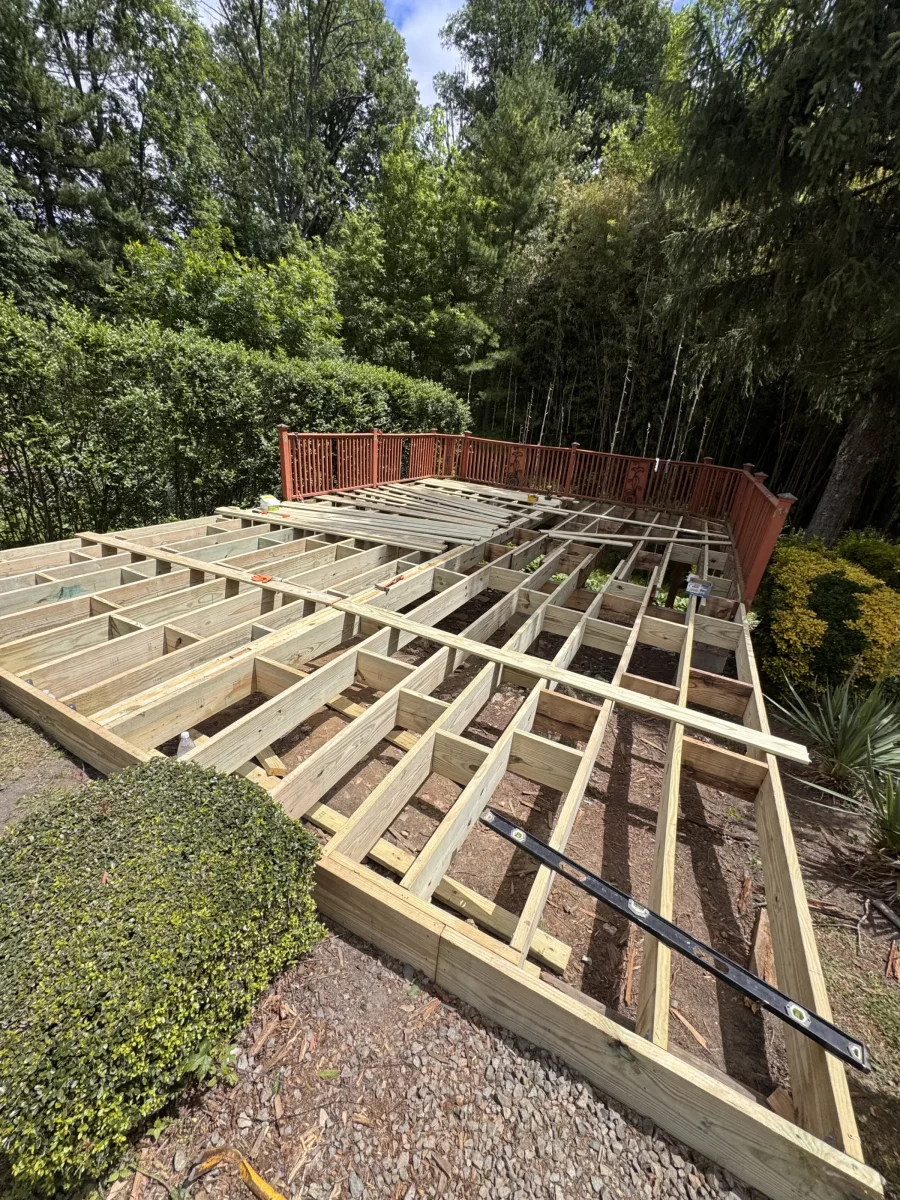 New joists and blocking laid out across the deck footprint