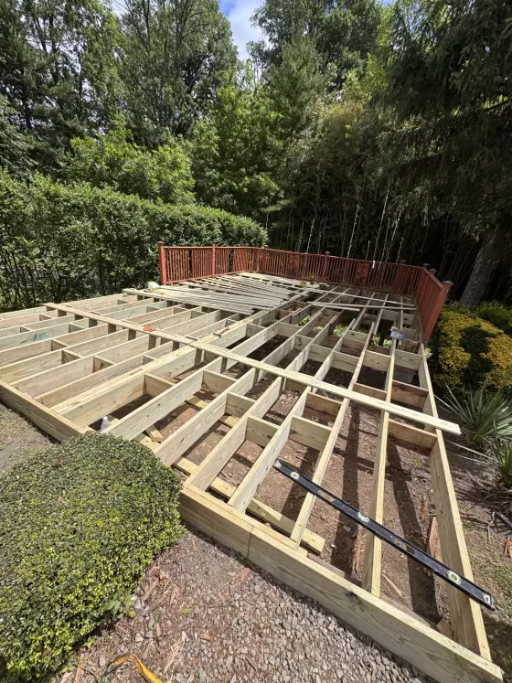 New joists and blocking laid out across the deck footprint