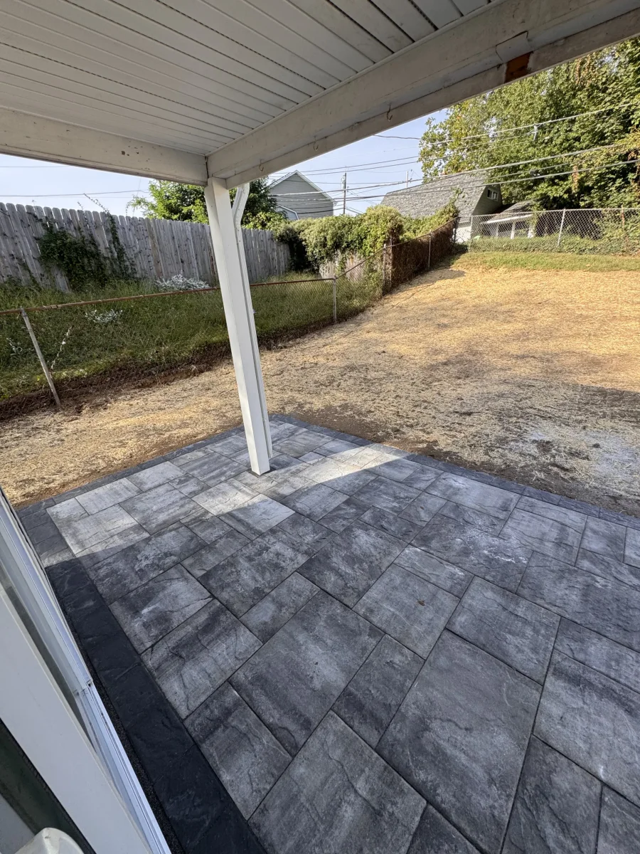 Covered porch over a gray paver patio